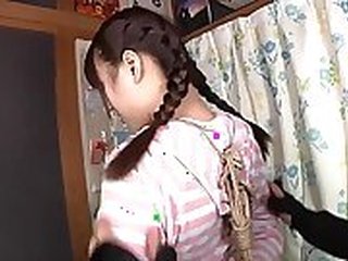 Concupiscent kinky Japanese whore in bondage uses stockings on snake lips